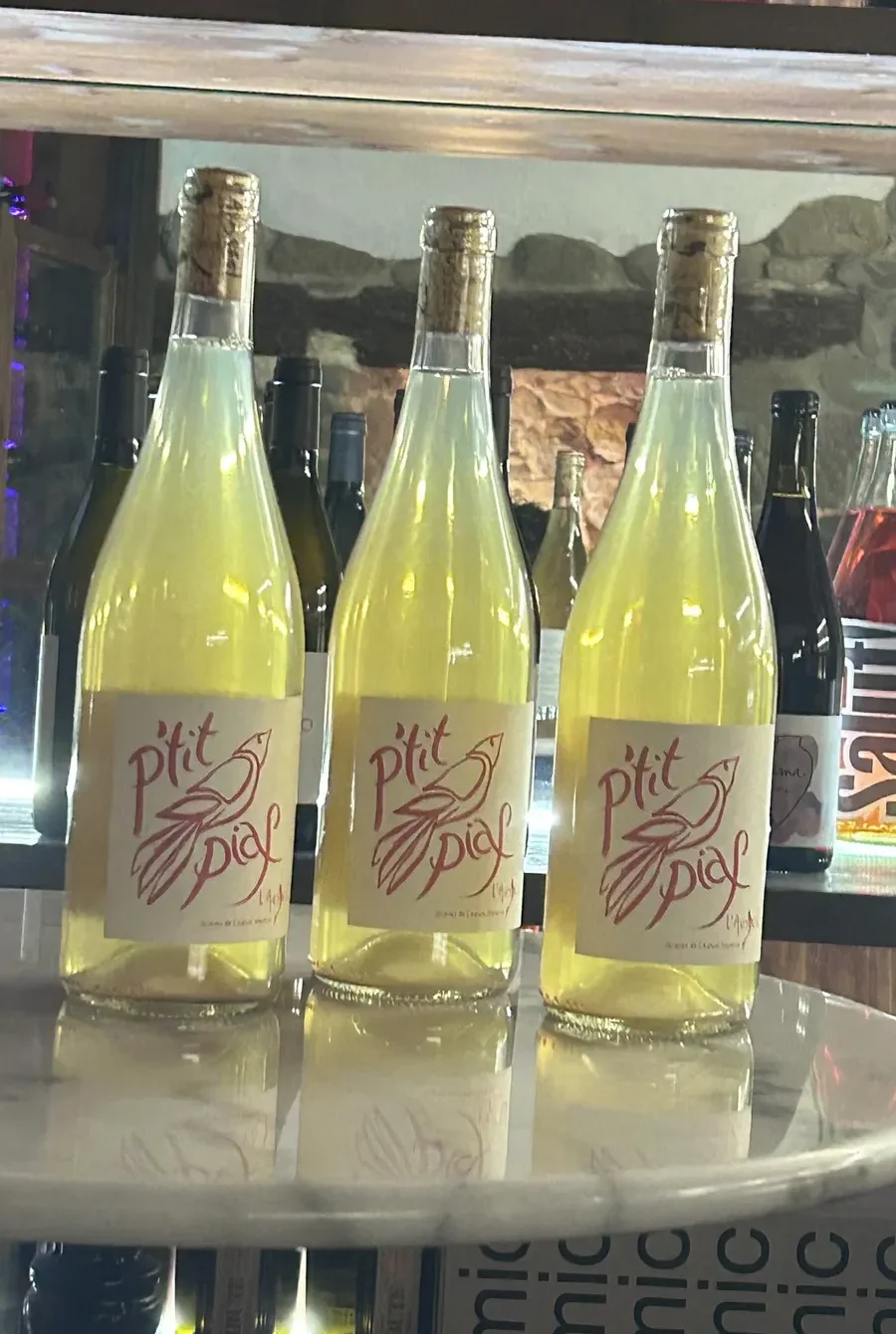 Ampolles de vins naturals seleccionats a Piola, restaurant especialitzat en vins naturals al centre de Vic.